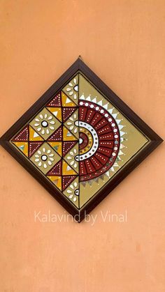 a decorative wall hanging on the side of a building with an intricately designed design