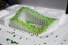 an architectural model of a building with trees growing out of it