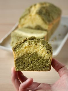 a hand holding up a piece of green cake