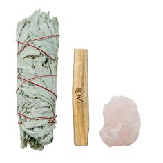 the sage smudge is next to a wooden stick and some cotton swabs