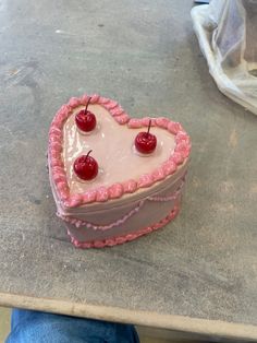 a heart shaped cake sitting on top of a table