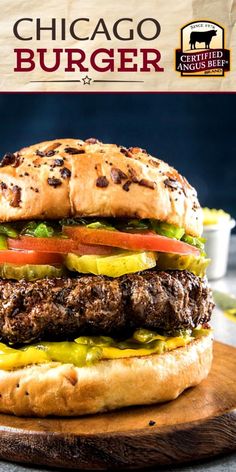 a large hamburger sitting on top of a wooden cutting board