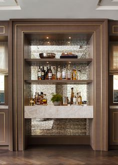 the shelves in this room are filled with bottles