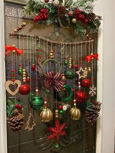 a door decorated for christmas with ornaments hanging from it's sides and decorations on the front