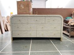 an old dresser sitting on top of a tiled floor