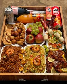 a wooden box filled with different types of food and drinks on top of a table