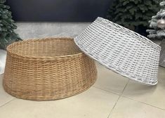 two wicker baskets sitting next to each other on the floor in front of christmas trees