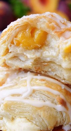 A close up photo of a peach pastry with a bite taken out of it. Apple Recipes With Puff Pastry, Puff Pastry Ingredients, Peach Puff Pastry, Peaches Cream Cheese, Cream Cheese Puffs, Cream Cheese Puff Pastry, Puff Dessert, Apple Cream Cheese