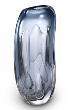 a glass vase with an abstract design on it's sides and the bottom part of its body