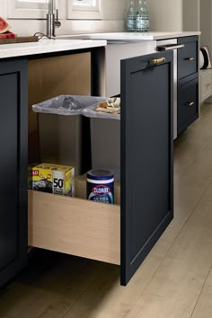 an open cabinet in the middle of a kitchen