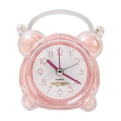 a pink alarm clock with two bells on the front and one at the top, is shown against a white background