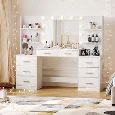 a bedroom with white furniture and lights on the ceiling, including a vanity table in front of a mirror