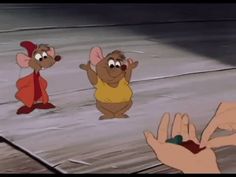 three cartoon mouses standing in front of a person's hand