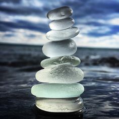 a stack of rocks sitting on top of the ocean