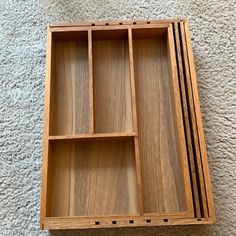 three wooden trays sitting on top of a carpeted floor