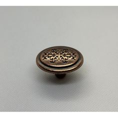 an antique brass cabinet knob with floral design