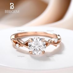 a close up view of a diamond ring on a white surface with the words bbebgem above it