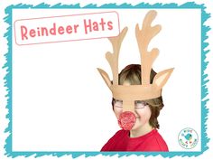 a young boy wearing reindeer antlers with a lollipop in front of his face