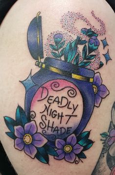 a woman's thigh with tattoos on it that says deadly night shade and flowers