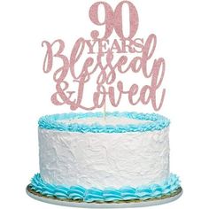 a cake with pink and blue frosting that says 90 years, belfested & loved