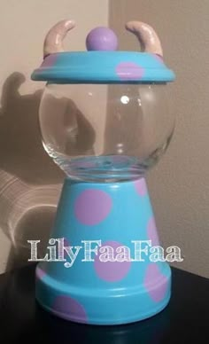 a blue and pink candy dispenser sitting on top of a black table