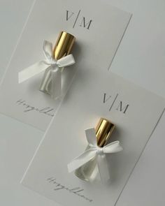 two white and gold napkins with bows on them