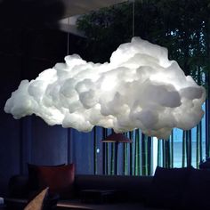 a cloud lamp hanging from the ceiling in a living room