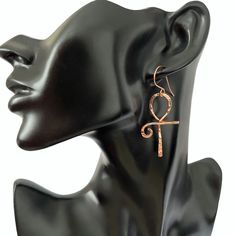 This pair of ankh earrings are lovely and symbolic. The ankh is an ancient Egyptian symbol which is also known as the key to the Nile and the key to life.  To make these earrings I formed  pure copper into the ankh shape and then lightly hammered the copper resulting in a beautiful texture which resembles diamond cuts.  To keep the copper tarnish free I coat the earrings with a tarnish resistant jewelry  protector. These earrings measures approximately 2 1/2 inches in length and 1 inch at widest point. Your earrings will arrive ready for gift giving in an organza gift bag or a cotton filled gift box  💝 Ankh-shaped Metal Earrings For Gift, Ankh Shaped Metal Earrings For Gift, Aluminum Wire Jewelry, Hoop Earrings Diy, The Ankh, Ancient Egyptian Jewelry, Wire Jewelry Earrings, Wire Wrap Jewelry Designs, Earthy Jewelry