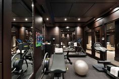 a gym with exercise equipment and mirrors