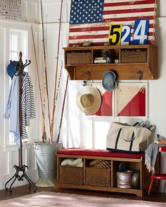 an american flag is hanging on the wall above a bench with baskets and umbrellas