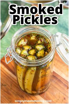 a jar filled with pickles sitting on top of a wooden table