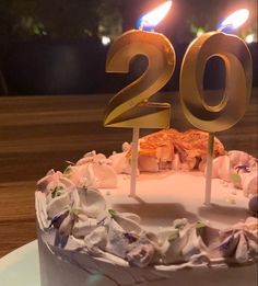 a birthday cake with two candles on it