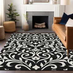 a black and white rug in front of a fireplace