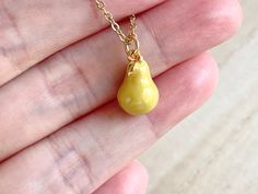 This dainty pear necklace is made of the followings: (1) gold plated green epoxy pear charm (14 x 8.5 mm) (2) gold plated or 14KGF chain and findings ✏️ Please choose the length of the chain (the length includes clasp and findings). ❣️ If you are unsure about which length to choose , please leave me a note to request an extension chain to be added to the chain at check out. 🍐EARRINGS 🍐 Hooks -> https://www.etsy.com/listing/919575709 🍐OTHER STYLE 🍐 YELLOW PEAR → https://www.etsy.com/listin Gold Pear-shaped Drop Necklace For Gift, Handmade Pear-shaped Necklace For Gift, Handmade Pear-shaped Necklace Gift, Handmade Pear-shaped Gold Necklace, Yellow Teardrop Necklace For Gifts, Pear-shaped Yellow Necklace For Gift, Pear Jewelry, Food Necklace, Fruit Necklace