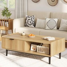 a living room with a couch, coffee table and baskets on the wall above it