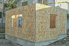 a house that is being built in the process of being constructed with plywood boards