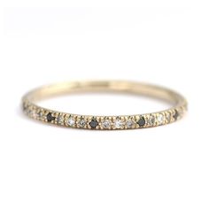 a gold band with black and white diamonds