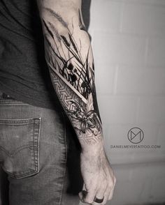 a man with a black and white tattoo on his arm