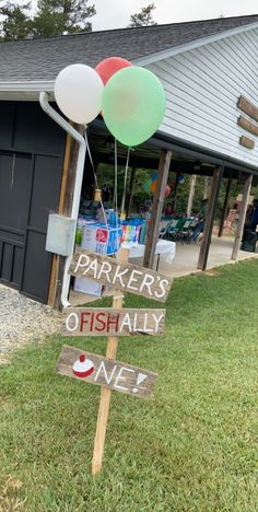 a sign that says parkers of fishally one with balloons attached to it