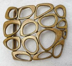 Vintage mid-century abstract modern brass buckle in excellent condition. Measures 2 ½” x 2 3/16”. Vintage Mid-Century Abstract Modern Modernist MCM Brass Buckle Vintage Mid-Century Abstract Modern Modernist MCM Brass Buckle Click images to enlarge Description Vintage mid-century abstract modern brass buckle in excellent condition. Measures 2 ½” x 2 3/16”. Payment PAYMENT VIA PAYPAL IS DUE WITHIN THREE DAYS OF PURCHASE. Shipping CONTINENTAL USA SHIPPING $6.00 is by USPS. Items are insured by Ship Modernist Jewelry Mid Century, Luxury Mid-century Hallmarked Jewelry, Mid-century Gold Brass Jewelry, Luxury Mid-century Metal Jewelry, Mid Century Modern Jewelry, Mid-century Silver Jewelry With Brooch, Bracelet Inspiration, Modernist Jewelry, Mid Century Vintage