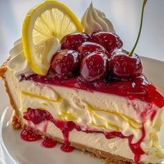 a piece of cheesecake with cherries and lemons on the top is sitting on a plate