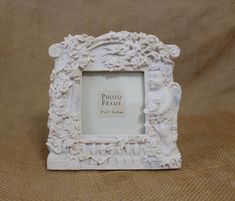 a white photo frame sitting on top of a bed