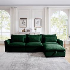 a large green couch sitting on top of a white rug