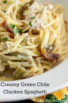 creamy green chile chicken spaghetti in a white bowl with parsley on top and text overlay