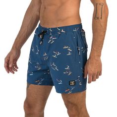 Ride the waves in style with our Caribbean Cove men's shorts. Inspired by the surf culture of the Caribbean, these shorts feature a trendy navy blue color scheme and a surf-inspired design. Perfect for the beach or the boardwalk, our shorts are made with high-quality materials that provide maximum comfort, durability, and flexibility. The elasticated waist and drawstring adjustment ensure a secure and comfortable fit, making them ideal for any activity. Whether you're surfing, swimming, or loung Hawaiian Style Surfing Shorts, Beachy Surfing Shorts For Summer, Beachy Shorts For Surfing In Summer, Casual Surfing Shorts, Beachy Shorts For Summer Surfing, Blue Hawaiian Shorts For Beach Season, Blue Beachy Shorts For Swimming, Blue Beachy Swim Shorts, Beachy Blue Swimming Shorts