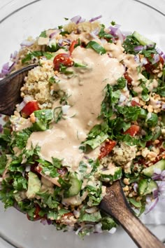 a salad with dressing in a glass bowl