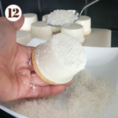 a person is scooping sugar out of a doughnut on top of white rice