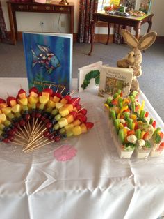 a table topped with lots of candy sticks and an animal figurine sitting on top of it