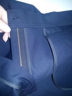 a person is holding their pants open and showing the side zippers on one end