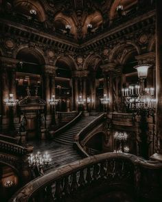 an ornate building with chandeliers and stairs